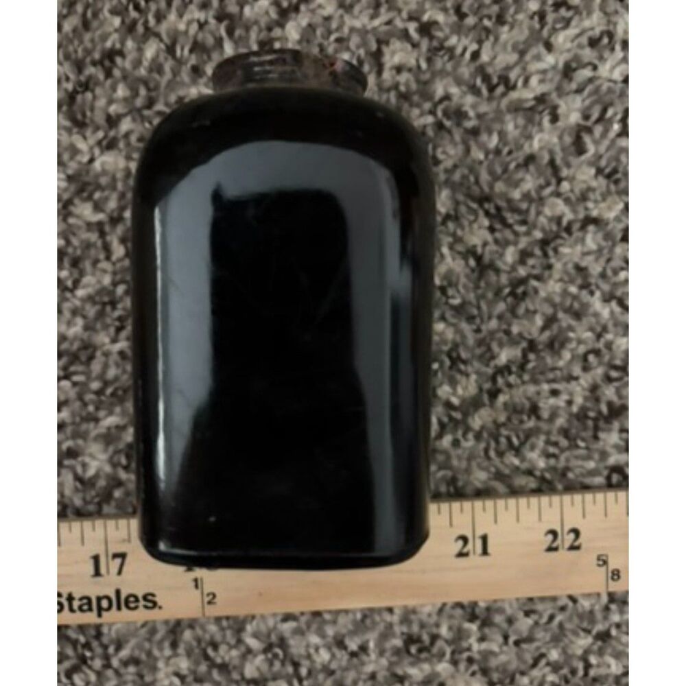 Vtg. glass medicine bottle - amber in light